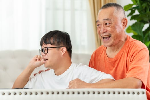 Senior man with grandchild relaxing together at home, Asian family play game in living room photo