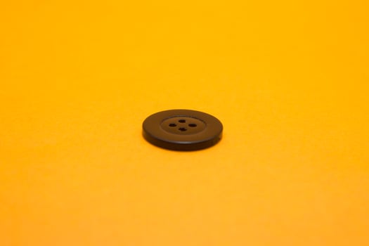 Black shirt buttons are isolated yellow background photo