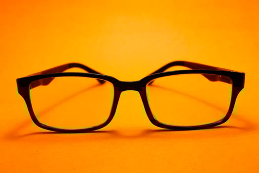 a pair of glasses isolated on yellow background photo