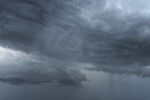 Dark, ominous storm clouds forming in the sky, signaling impending heavy rain. photo