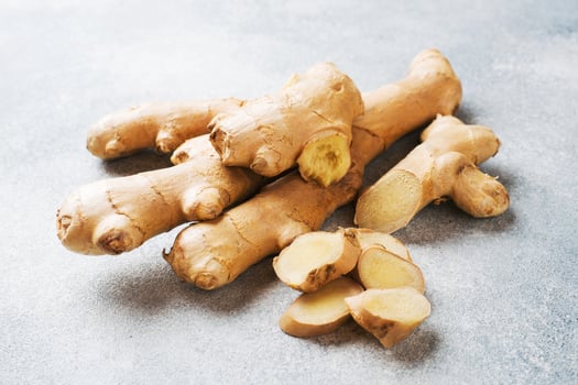 Fresh ginger root on grey background. Copy space. photo