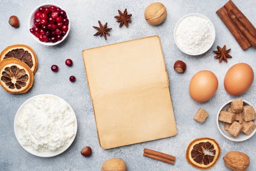 Ingredients for baking cookies, cupcakes and cake. Frame of Raw foods eggs flour sugar cottage cheese cranberries on a grey background with copy space. photo