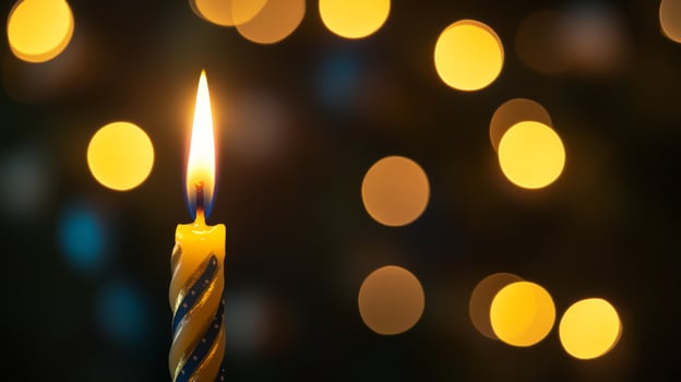A Single Birthday Candle Burning Brightly with a Bokeh Background photo