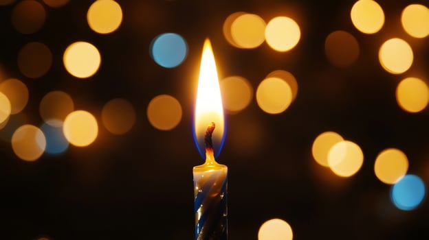 A Single Birthday Candle Burning With Bokeh Lights in the Background photo