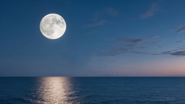 full moon rising over empty ocean at night with copy space. photo