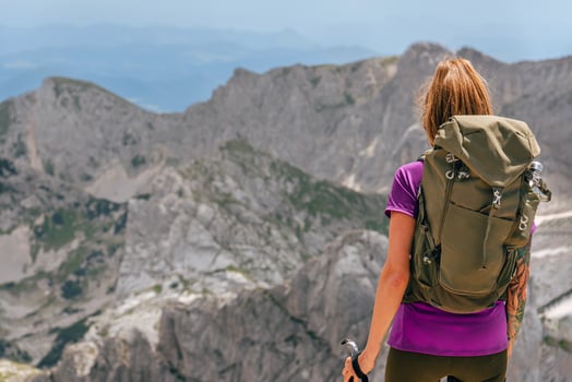 Woman Backpacker Standing Backwards Looking Away photo