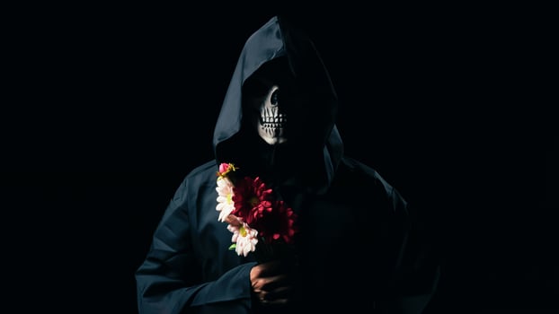 black death holds flowers in his hand photo