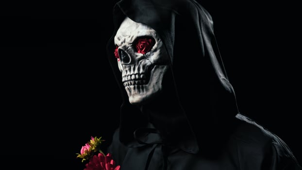 Dead man mask with a bouquet of flowers photo