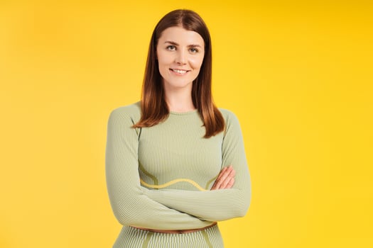 Confident, successful, smiling female athlete with crossed arms wearing stylish sports uniform photo