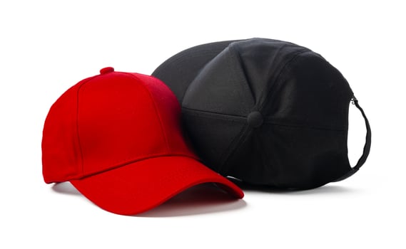 Black and Red Baseball Caps on White Background photo