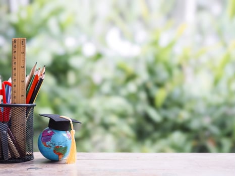 Student creative desktop, Colorful stationery and earth globe with graduation hat. Copy space for text, Back to school, Education concept photo