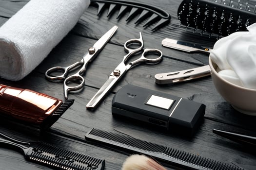 Professional Barber Tools Laid Out on Dark Wooden Surface photo