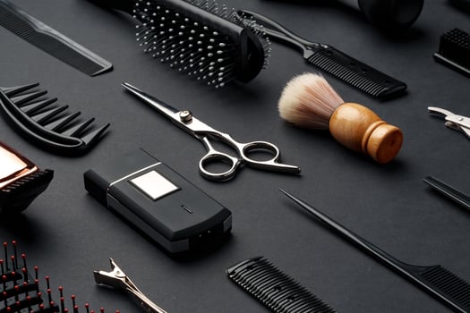 Variety of Hair Styling Tools and Accessories Displayed on a Dark Background photo
