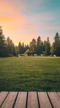 Lush green field at dawn, wooden platform and campsite with serene atmosphere Vertical Mobile Wallpaper photo