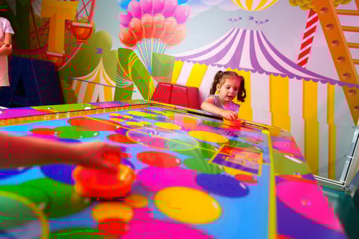 Young Girl Engaging in Colorful Board Game Fun at a Vibrant Playroom photo