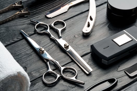 Professional Barber Tools Laid Out on Dark Wooden Surface photo