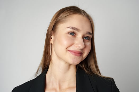 Young Woman in Black Jacket Posing to Camera against gray background photo