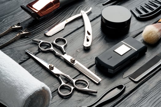 Professional Barber Tools Laid Out on Dark Wooden Surface photo