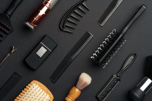 Variety of Hair Styling Tools and Accessories Displayed on a Dark Background photo