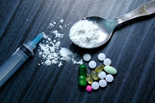 A Variety of Assorted Drugs and Prescription Medications Arranged on a Dark Surface photo