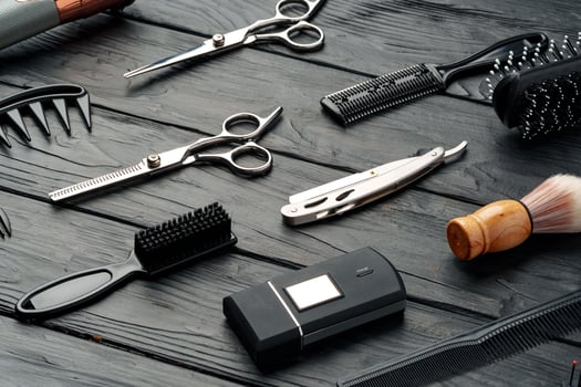 Professional Barber Tools Laid Out on Dark Wooden Surface photo