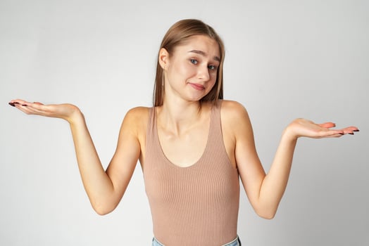 Clueless Young Woman Holding Out Her Hands Gesturing She Doesn't Know photo