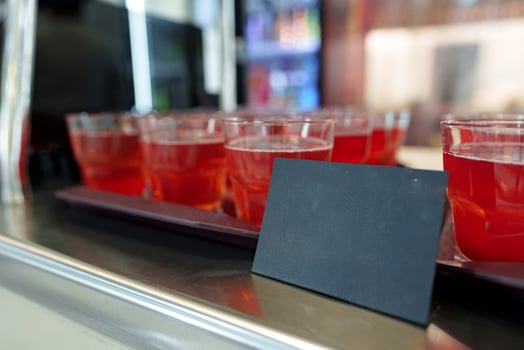 Colorful Array of Fruit Juice Cups on a Serving Cart in a Cafeteria photo
