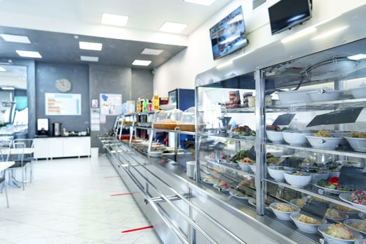 Bustling Cafeteria Serving Line During Lunchtime Offering a Variety of Dishes photo