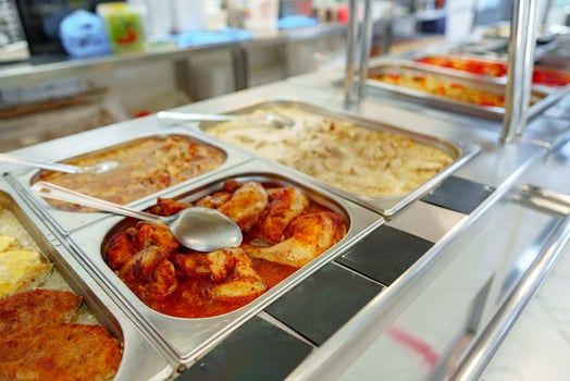 Bustling Cafeteria Serving Line During Lunchtime Offering a Variety of Dishes photo