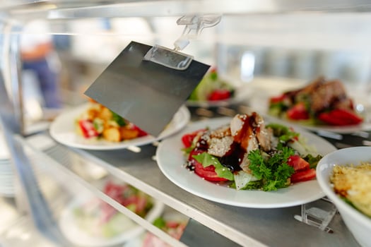 Freshly Prepared Salads on Display in a Cafeteria During Lunchtime photo