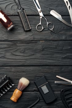 Professional Barber Tools Laid Out on Dark Wooden Surface photo