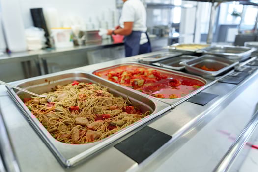 Bustling Cafeteria Serving Line During Lunchtime Offering a Variety of Dishes photo