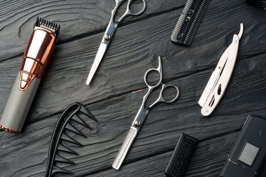 Professional Barber Tools Laid Out on Dark Wooden Surface photo