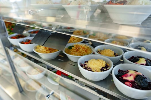 Bustling Cafeteria Serving Line During Lunchtime Offering a Variety of Dishes photo