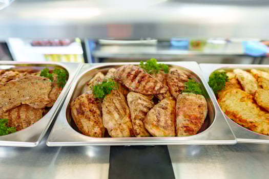 Grilled Chicken Breasts and Pork Cutlets Served in a Buffet Setting photo