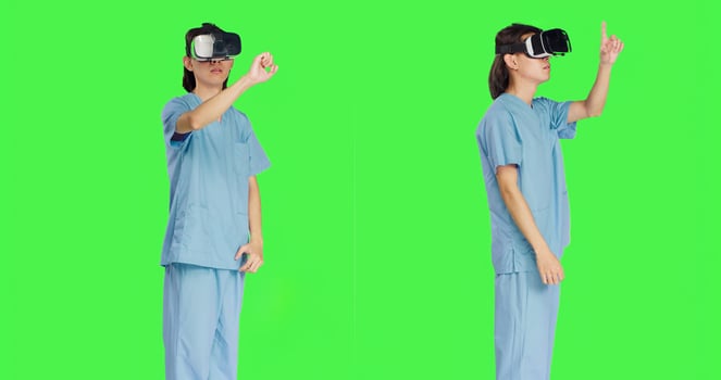 Operating with advanced interactive 3d headset, nursing staff uses virtual reality goggles against greenscreen backdrop. Artificial intelligence utilized by medical healthcare professionals. photo