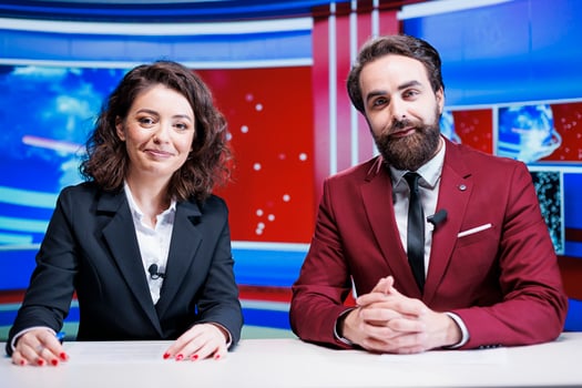 Media newscasters going live on tv to deliver breaking news and global events, broadcasting morning show content on television program network. Team of reporters reading headlines in newsroom. photo