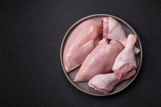 Pieces of raw chicken or turkey fillet with salt, spices and herbs photo