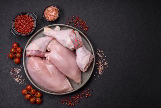 Pieces of raw chicken or turkey fillet with salt, spices and herbs photo