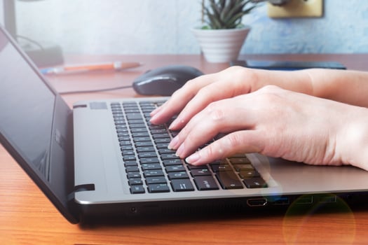 Working wooden table at home or in the office. Woman working at computer hands photo