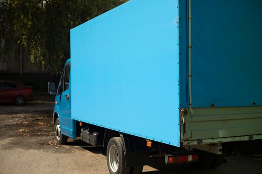 Blue Truck. Cargo transportation in the city. Blue awning on the body. photo