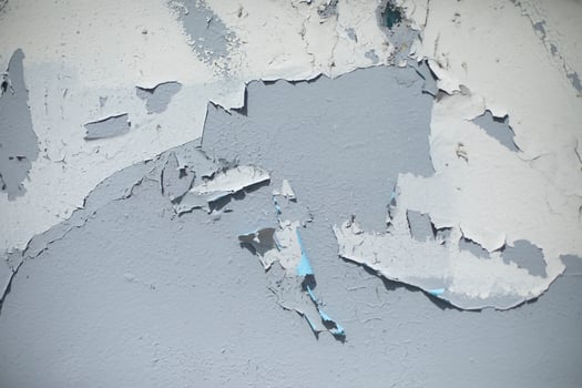 Old paint on gray wall. Flying paint. Ruined background. photo