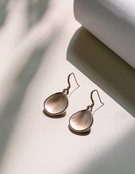 Minimalist Jewelry. Simple earrings placed on a clean table photo