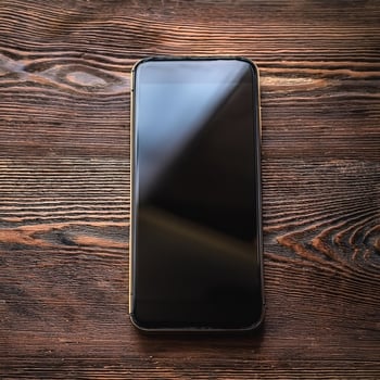 The latest smartphone lies on a wooden table. Technology Gadgets photo