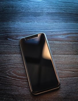 The latest smartphone lies on a wooden table. Technology Gadgets photo