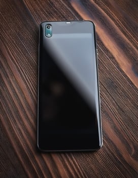 The latest smartphone lies on a wooden table. Technology Gadgets photo