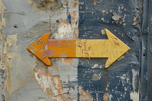 Double yellow arrow sign pointing right on grunge wall background photo