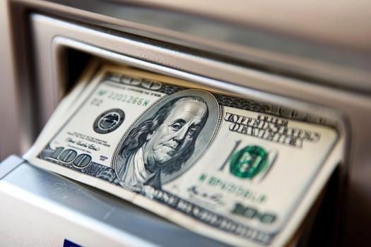 Atm cash machine dispensing one hundred dollar bill photo