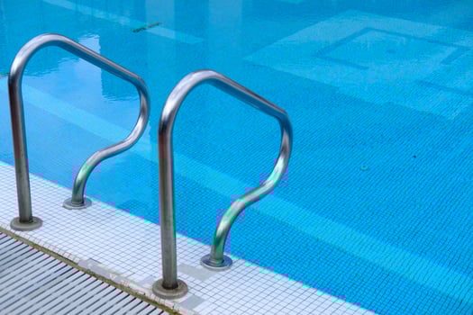 This stylish swimming pool has stainless steel railings, ideal for summer relaxation photo