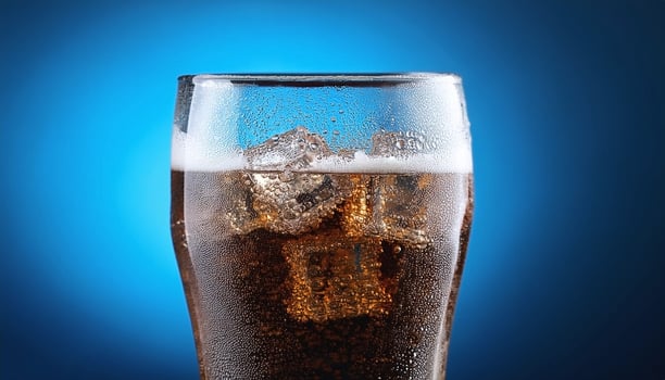 Carbonated soda glass on blue background photo